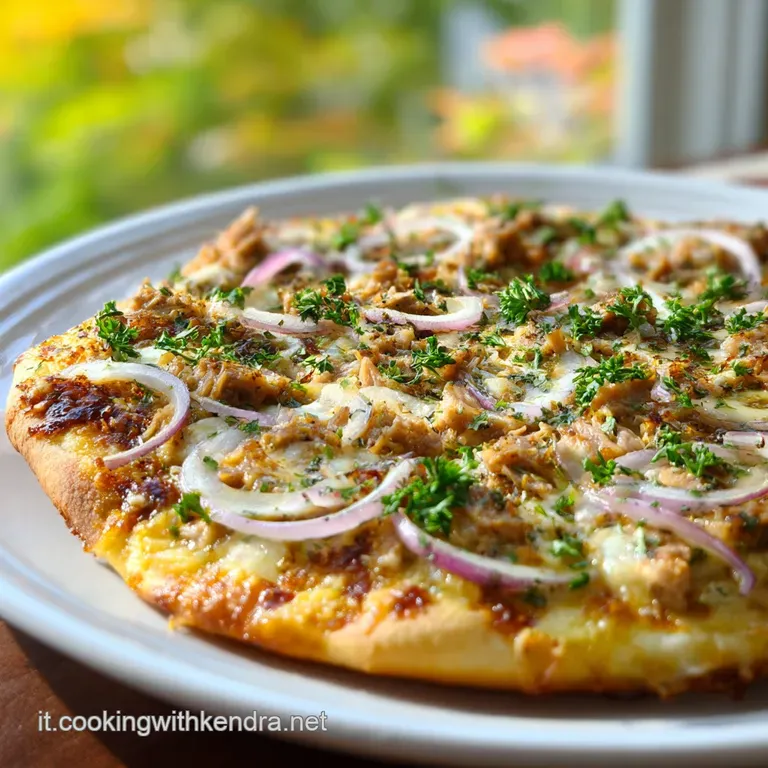 A slice of homemade pizza with bubbly cheese, savory tuna, and red onion is presented on a white plate with basil garnish.